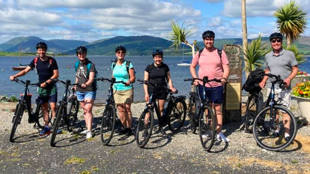 Row of cyclists on Rothesay with e-bikes